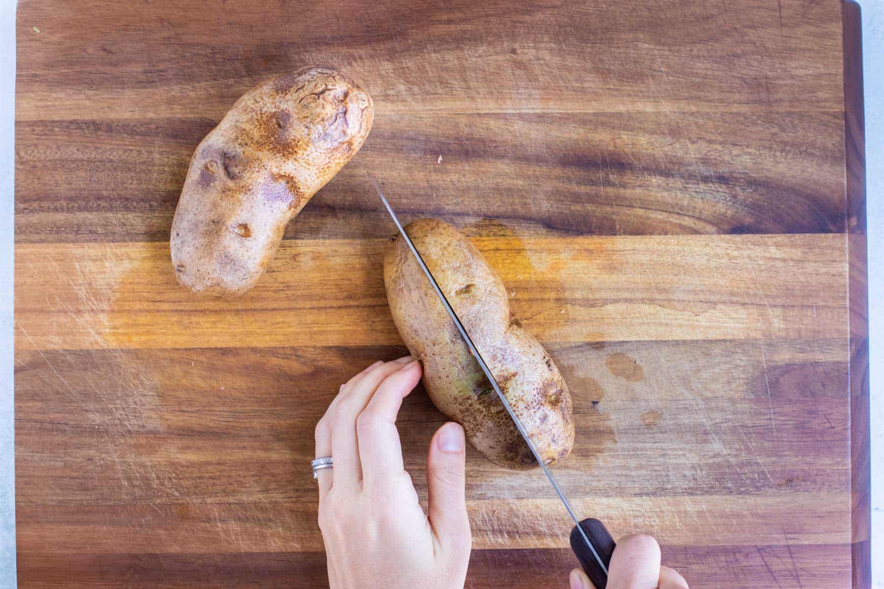 Russet potatoes are cut in half.