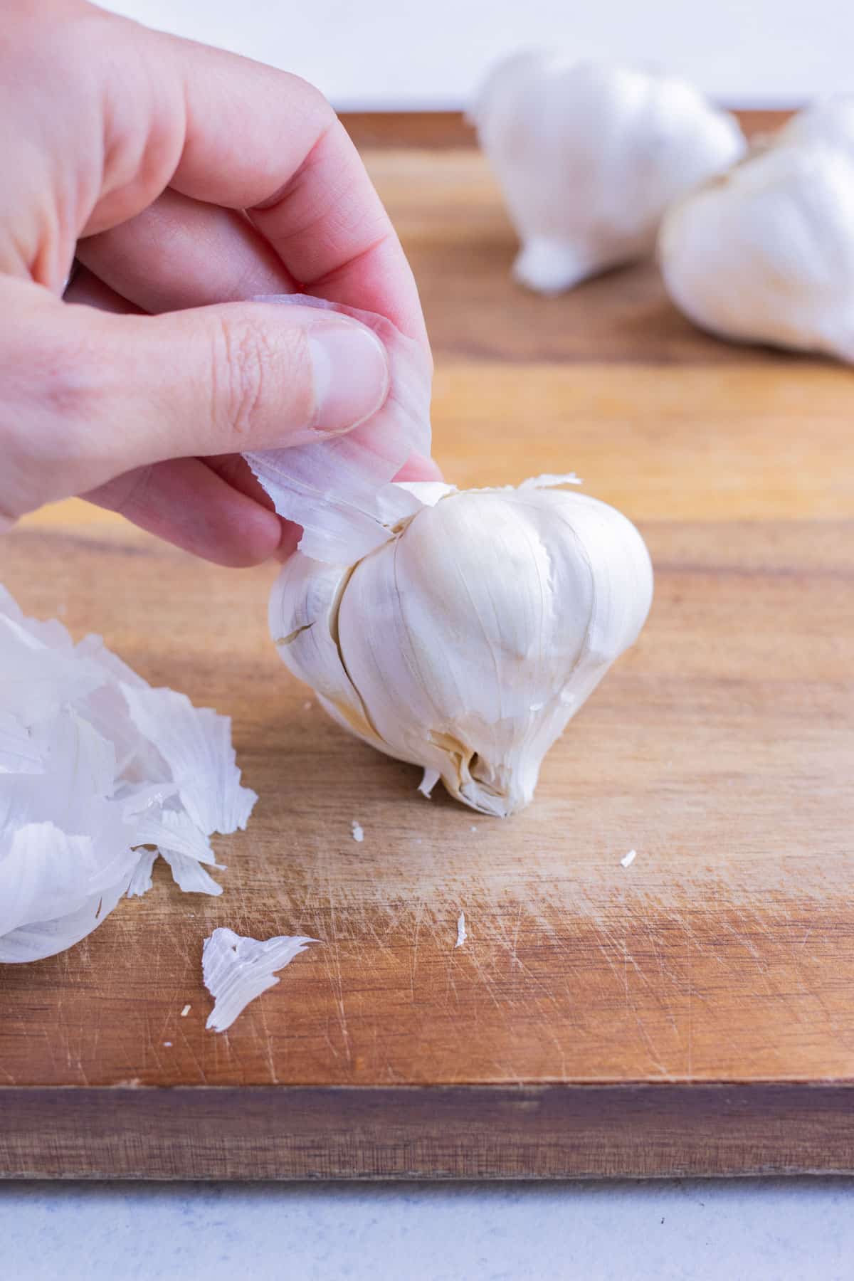 The garlic is completely peeled with a hand.
