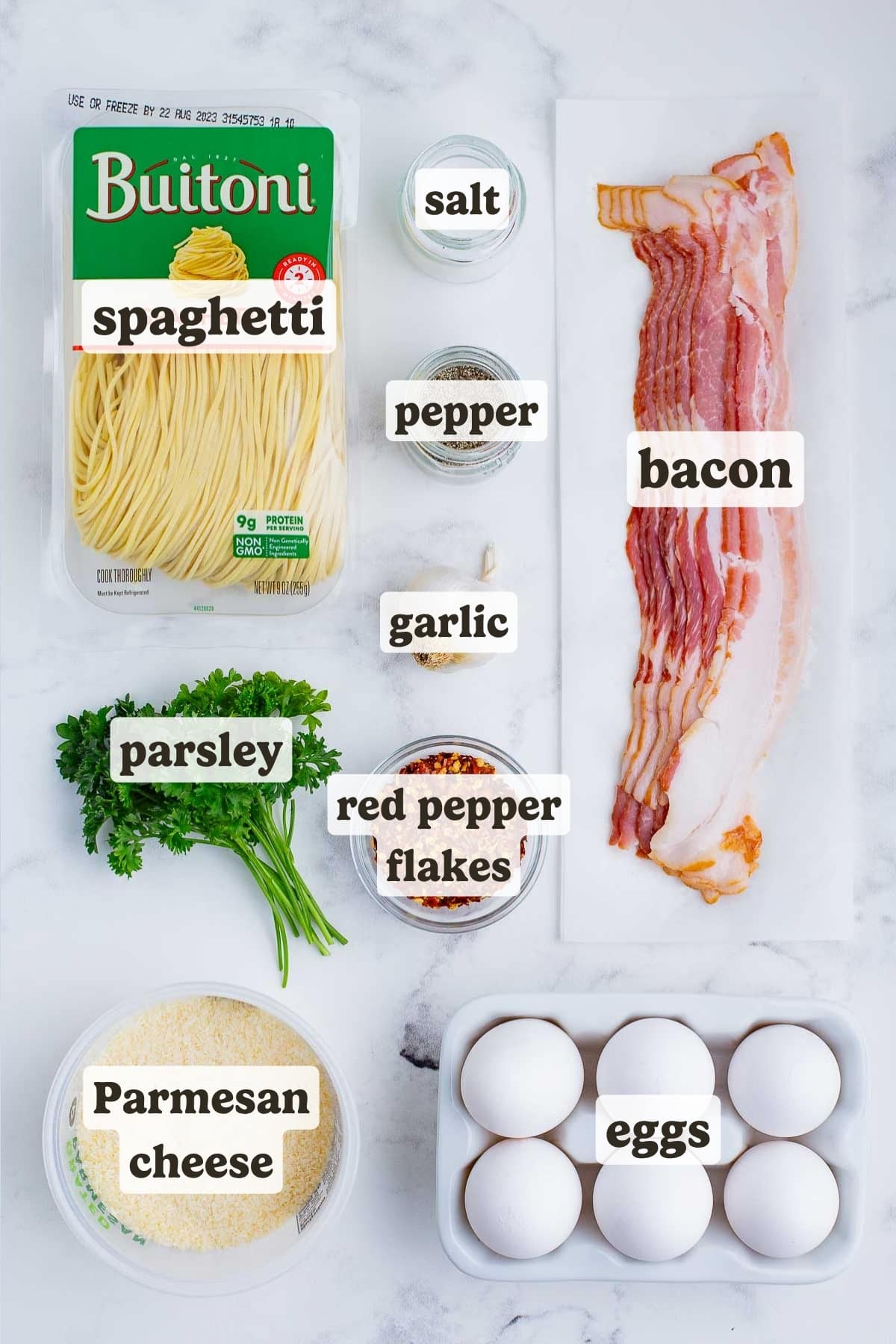 Noodles, bacon, eggs, cheese, and herbs are the ingredients for this pasta carbonara dish.