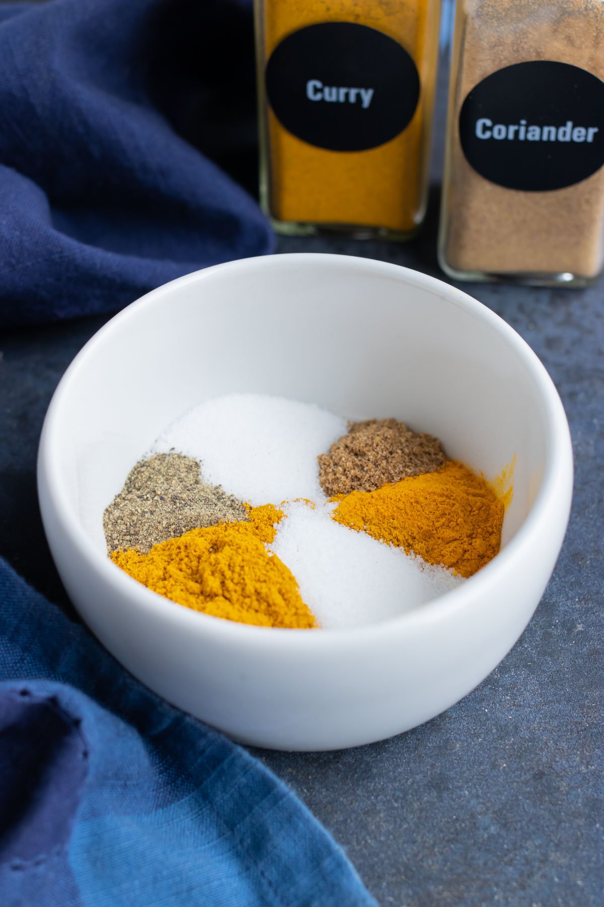 Homemade yellow curry seasoning blend with curry powder and turmeric.