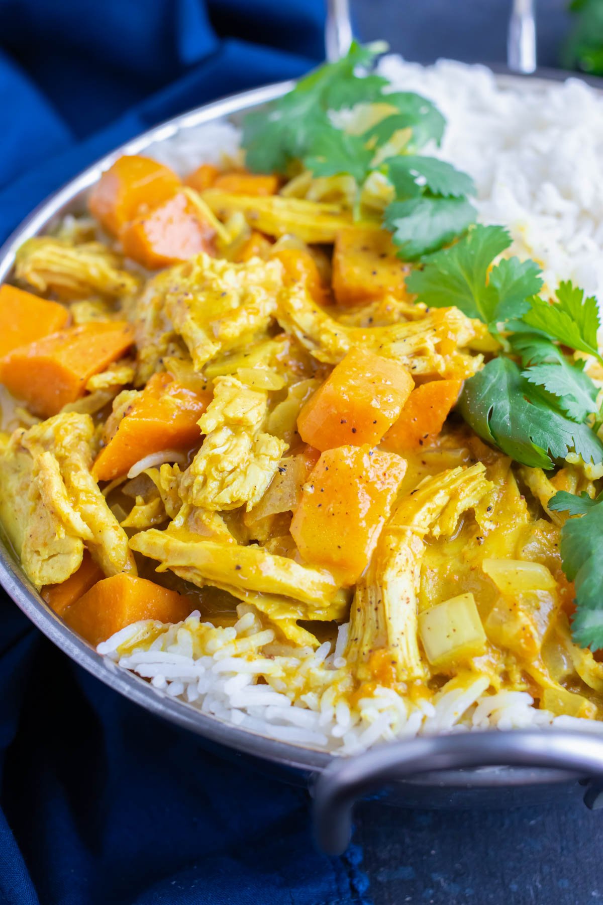 Slow cooker chicken curry with potatoes, coconut milk, and served with white basmati rice.