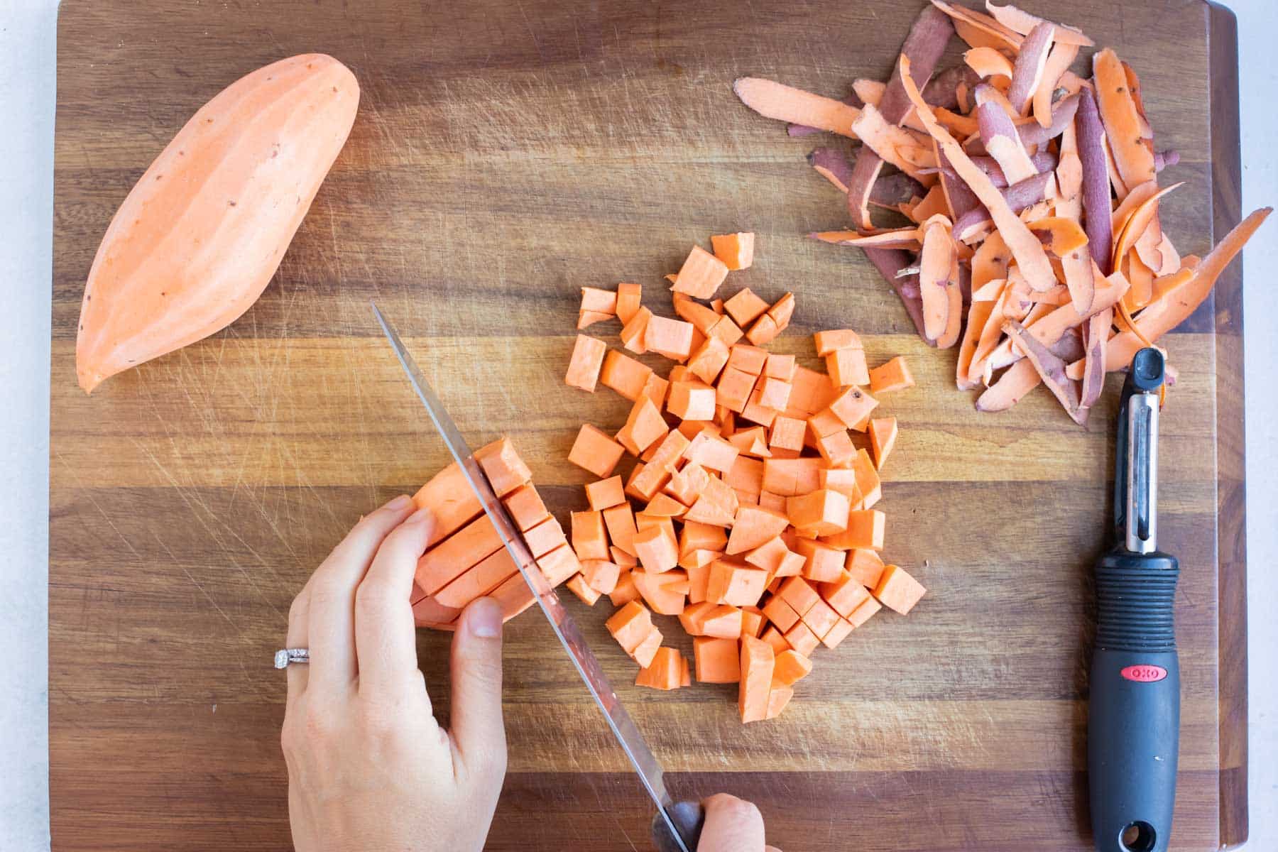Sweet potato is peeled and diced for this vegetarian dish.