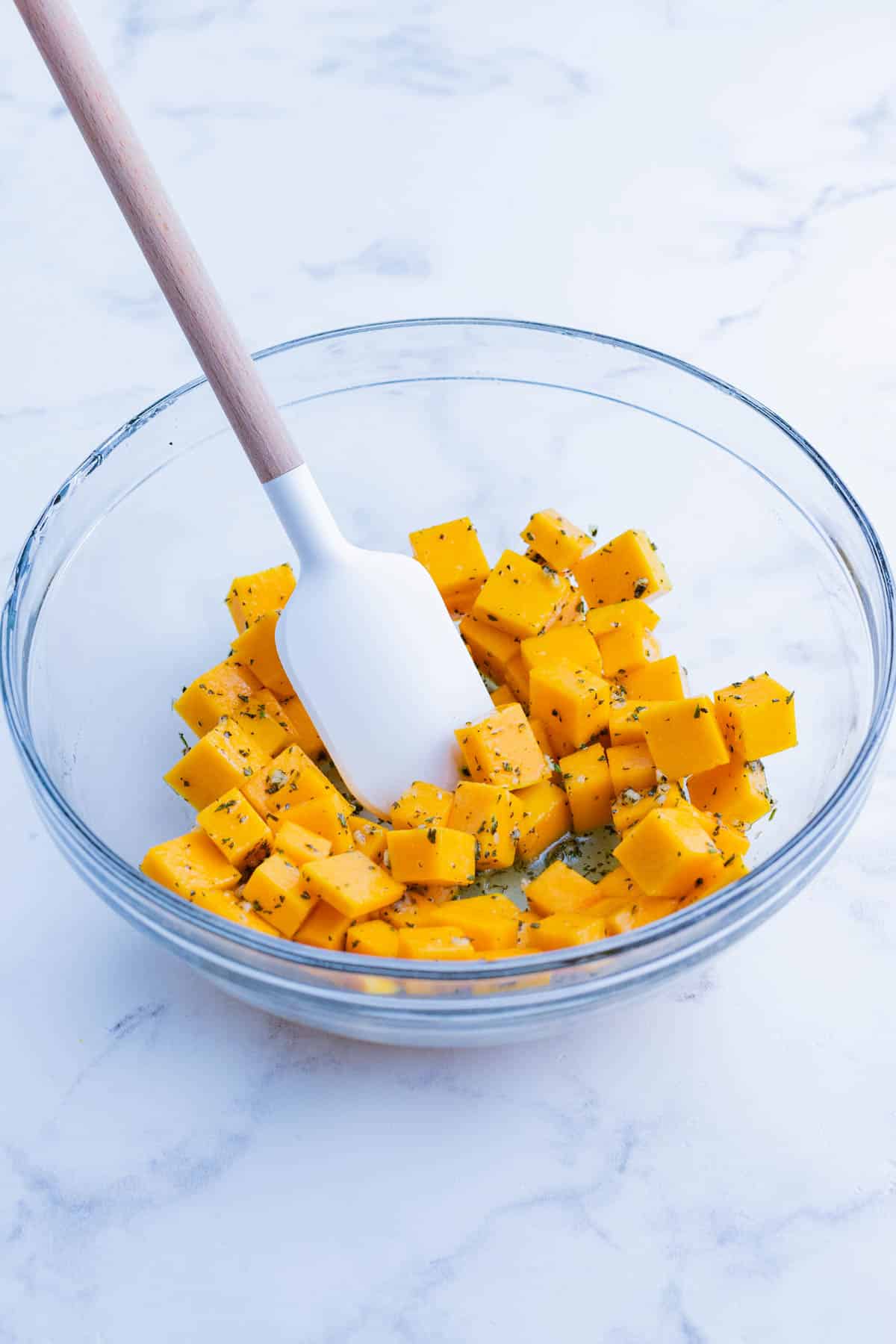Butternut squash cubes are seasoned with the sauce.