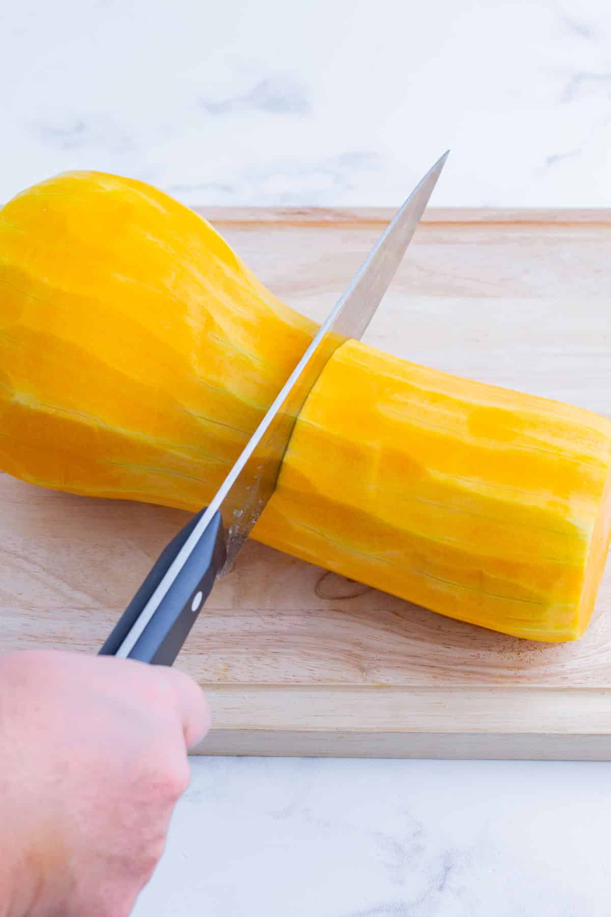 Butternut squash is cut in half.