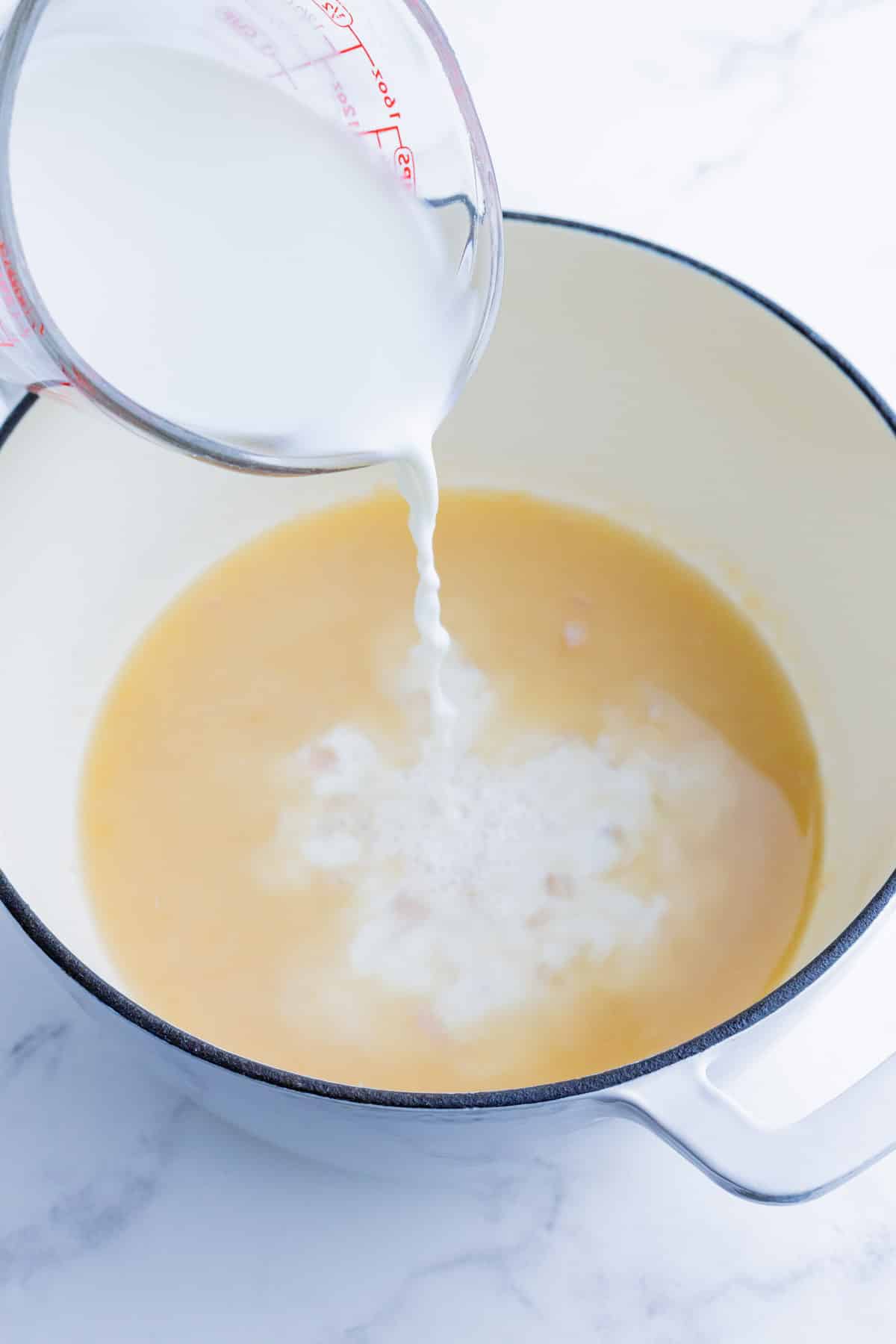 Milk is added to the mac and cheese base.
