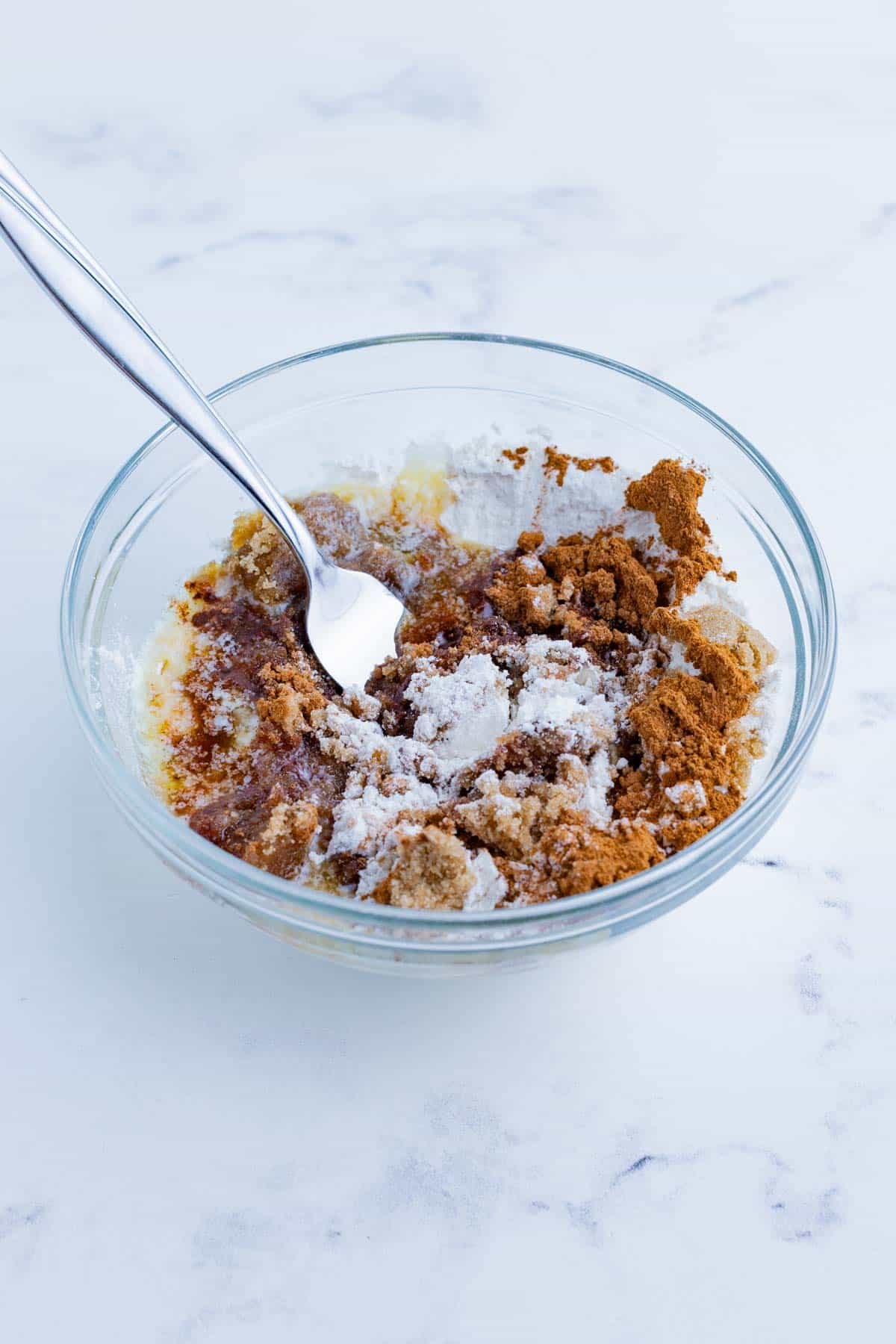 The crumble topping is mixed in a bowl.