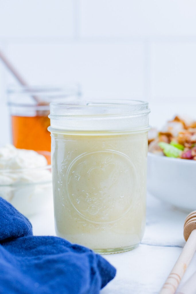 A mason jar is full of creamy cobb salad dressing.