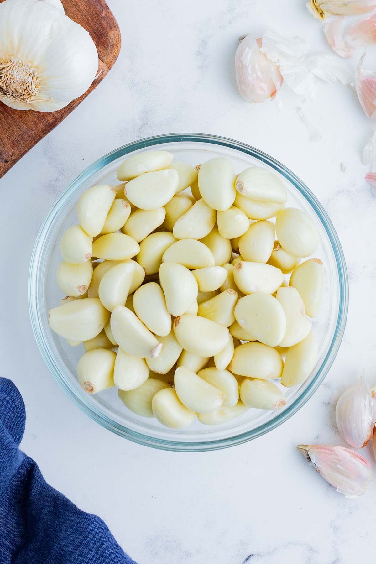 Peeled garlic cloves in a glass bowl.