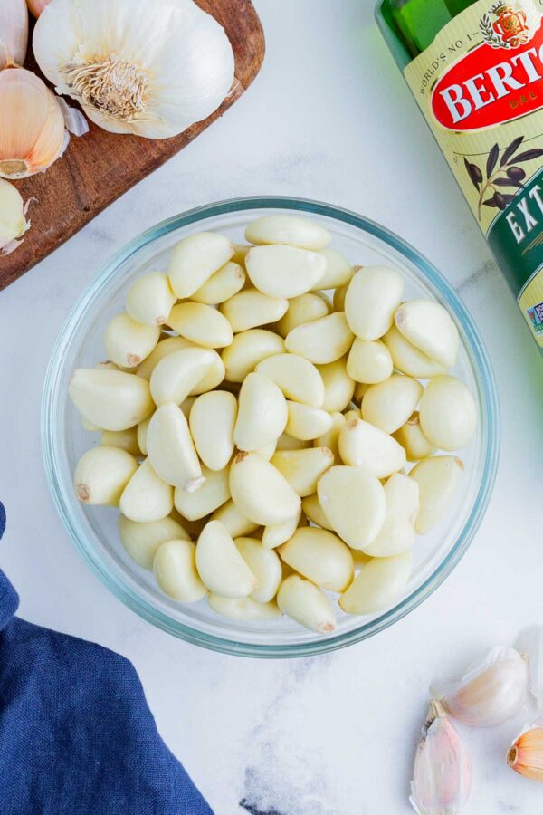 Peeled garlic cloves in a glass bowl.