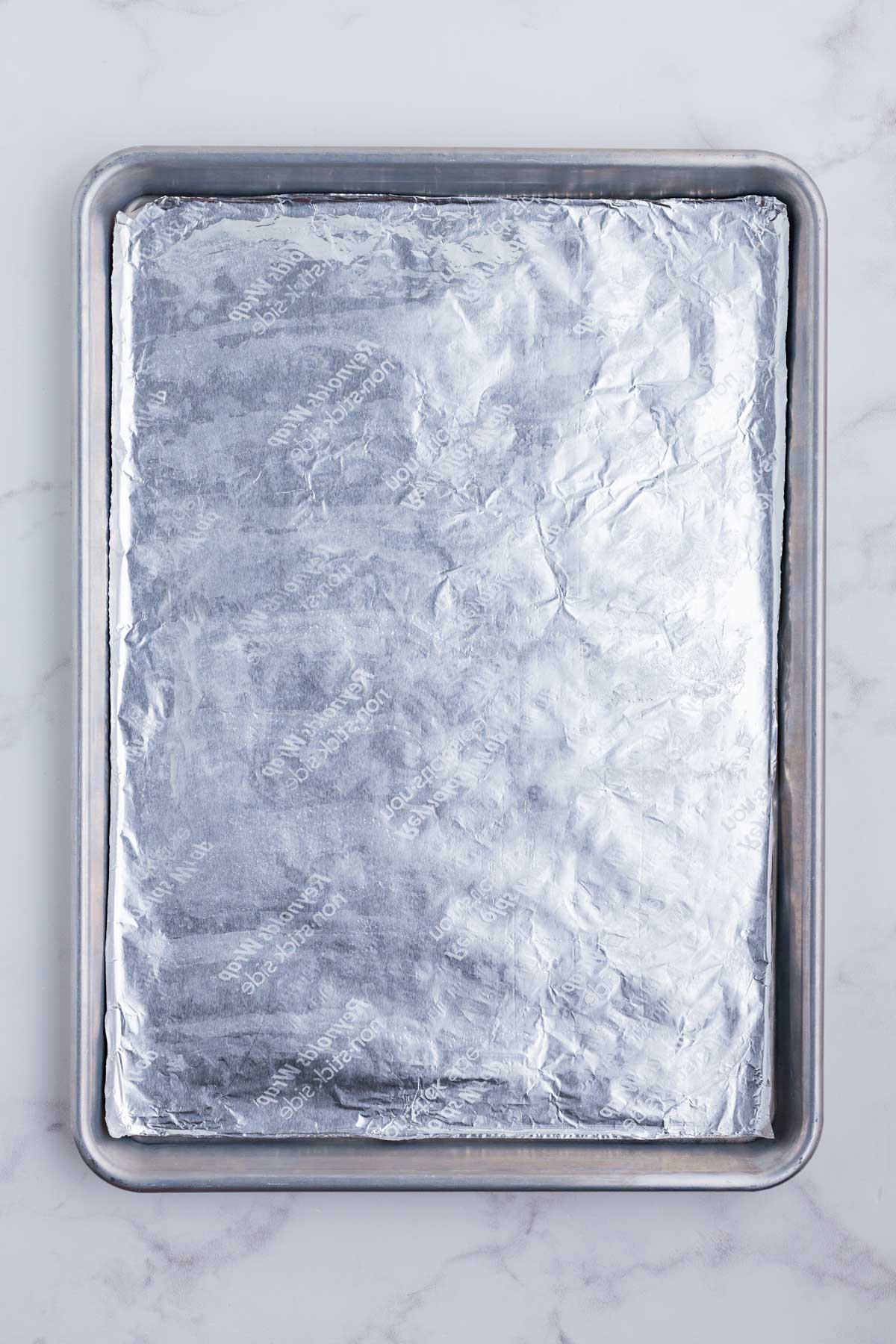 A baking sheet is lined with foil.