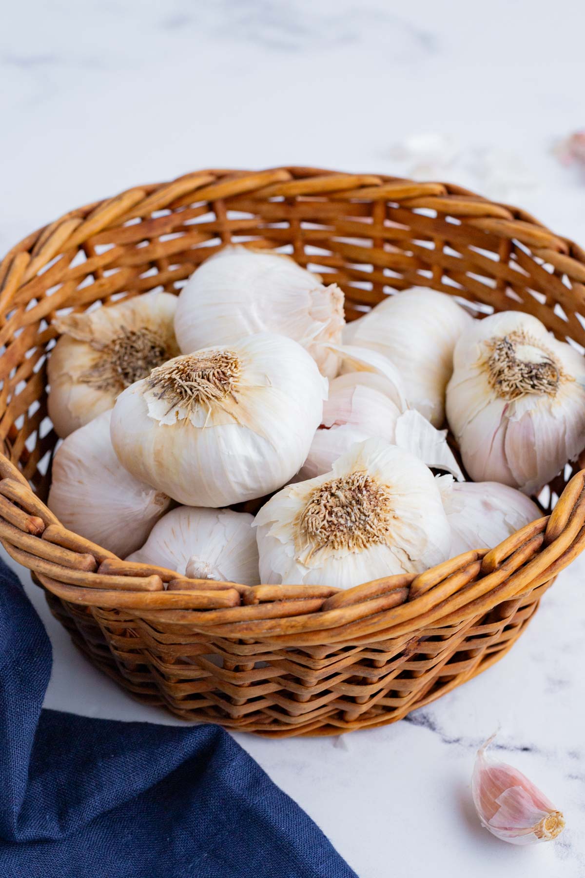 Multiple heads of garlic in a basket.