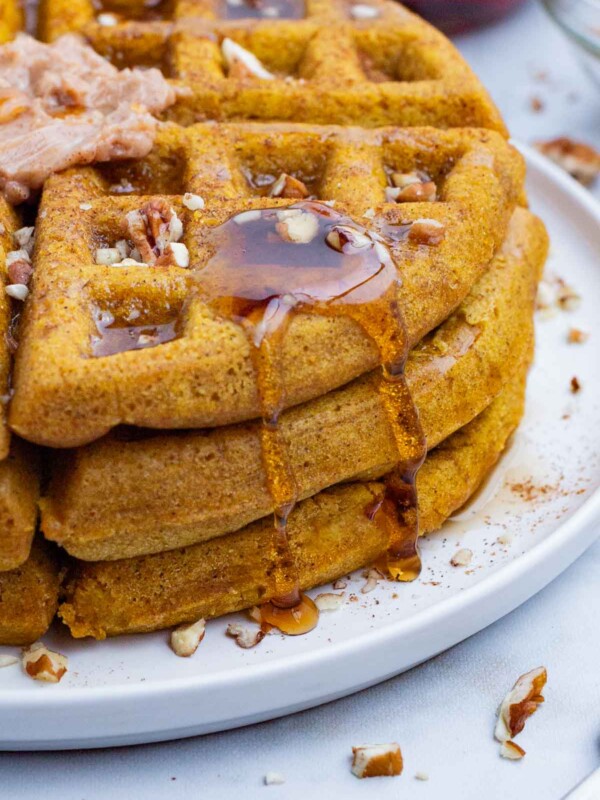Pumpkin waffles topped with syrup and maple butter is a perfect fall morning.