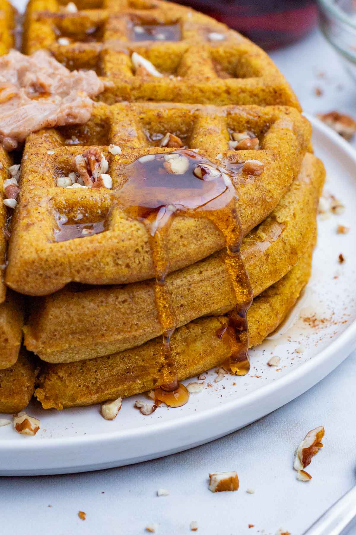 Pumpkin waffles topped with syrup and maple butter is a perfect fall morning.