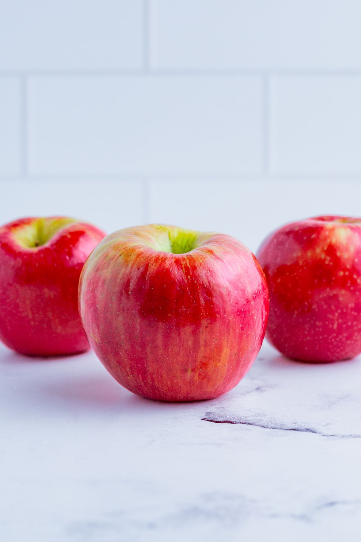 3 Ambrosia apples on the counter top.