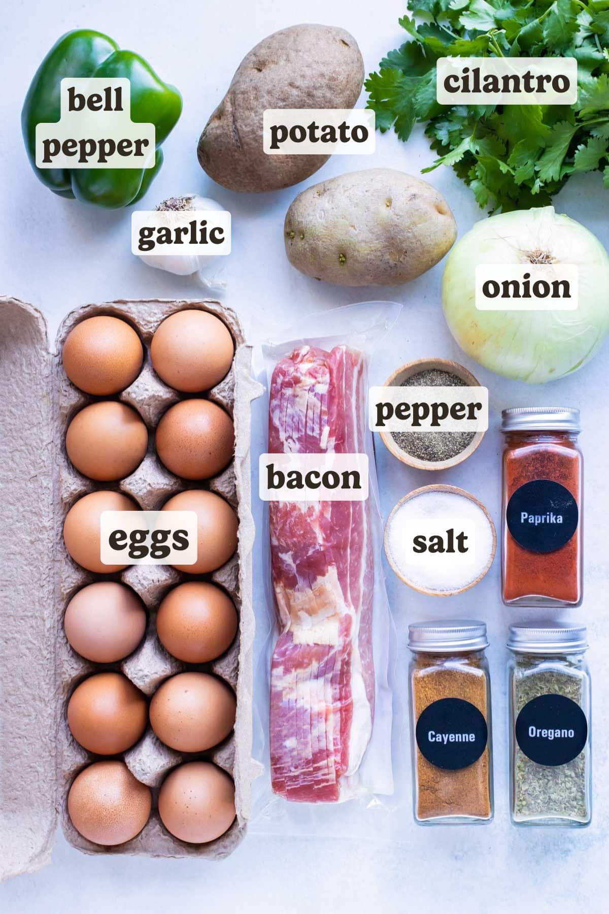 Eggs, bacon, seasonings, potatoes, and vegetables are the ingredients needed for this breakfast hash recipe.