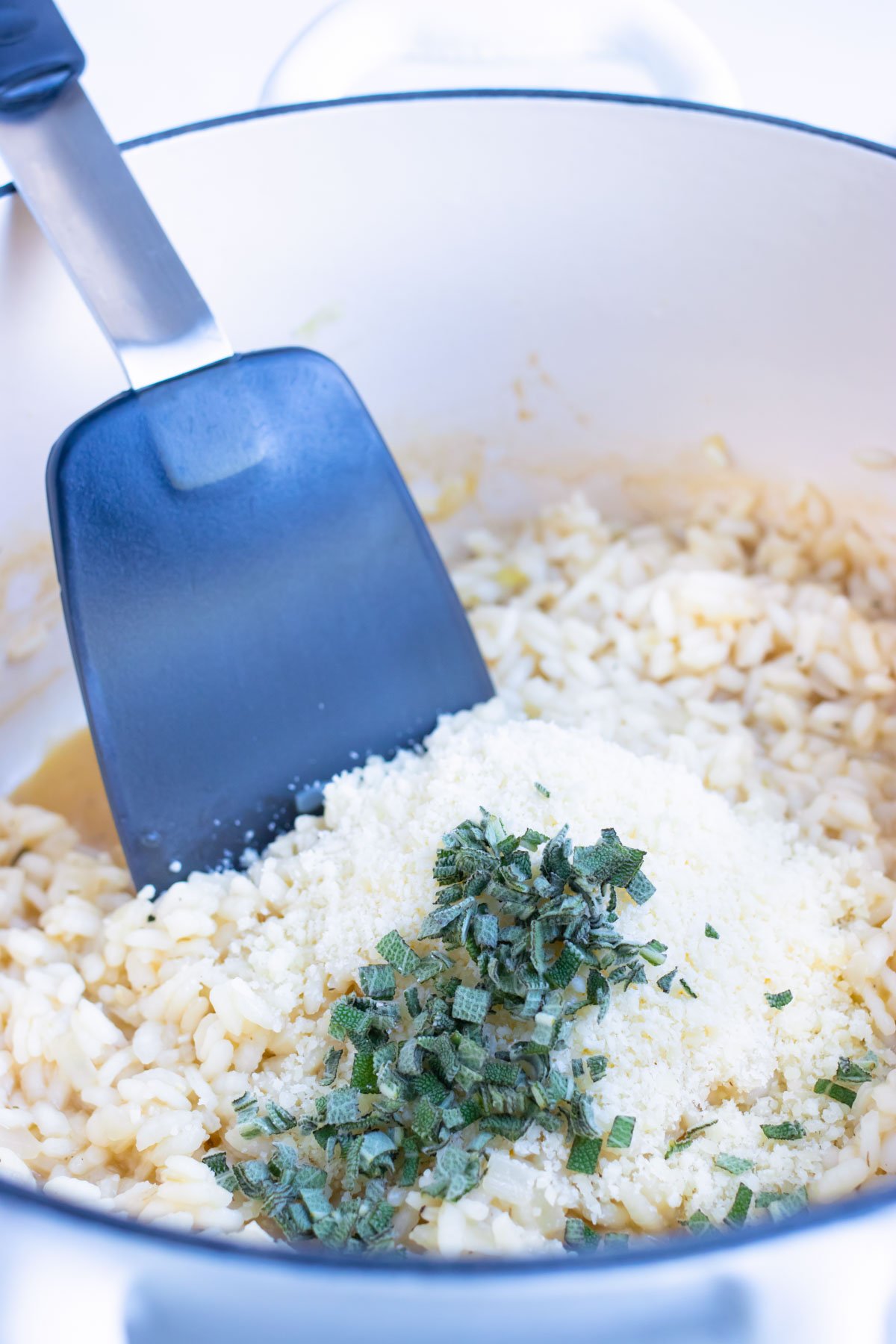 Parmesan cheese and herbs are added to the arborio rice.