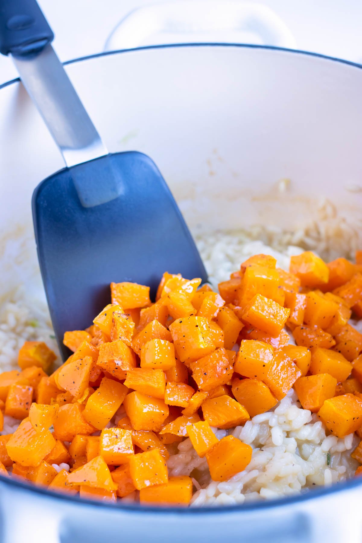 Roasted butternut squash is added to the rice, herb, and parmesan mixture.