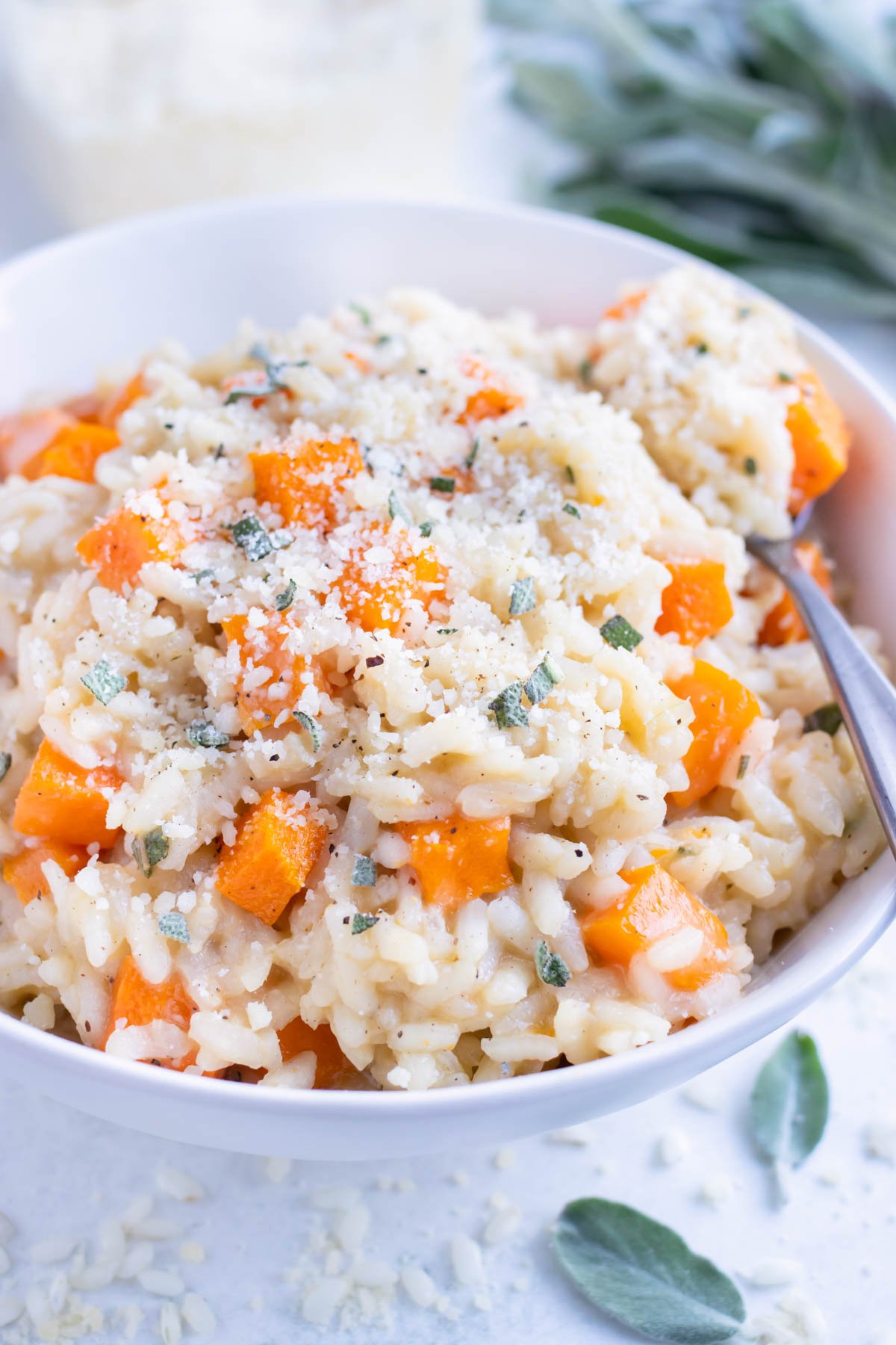 Butternut squash risotto is enjoyed with a spoon for dinner.