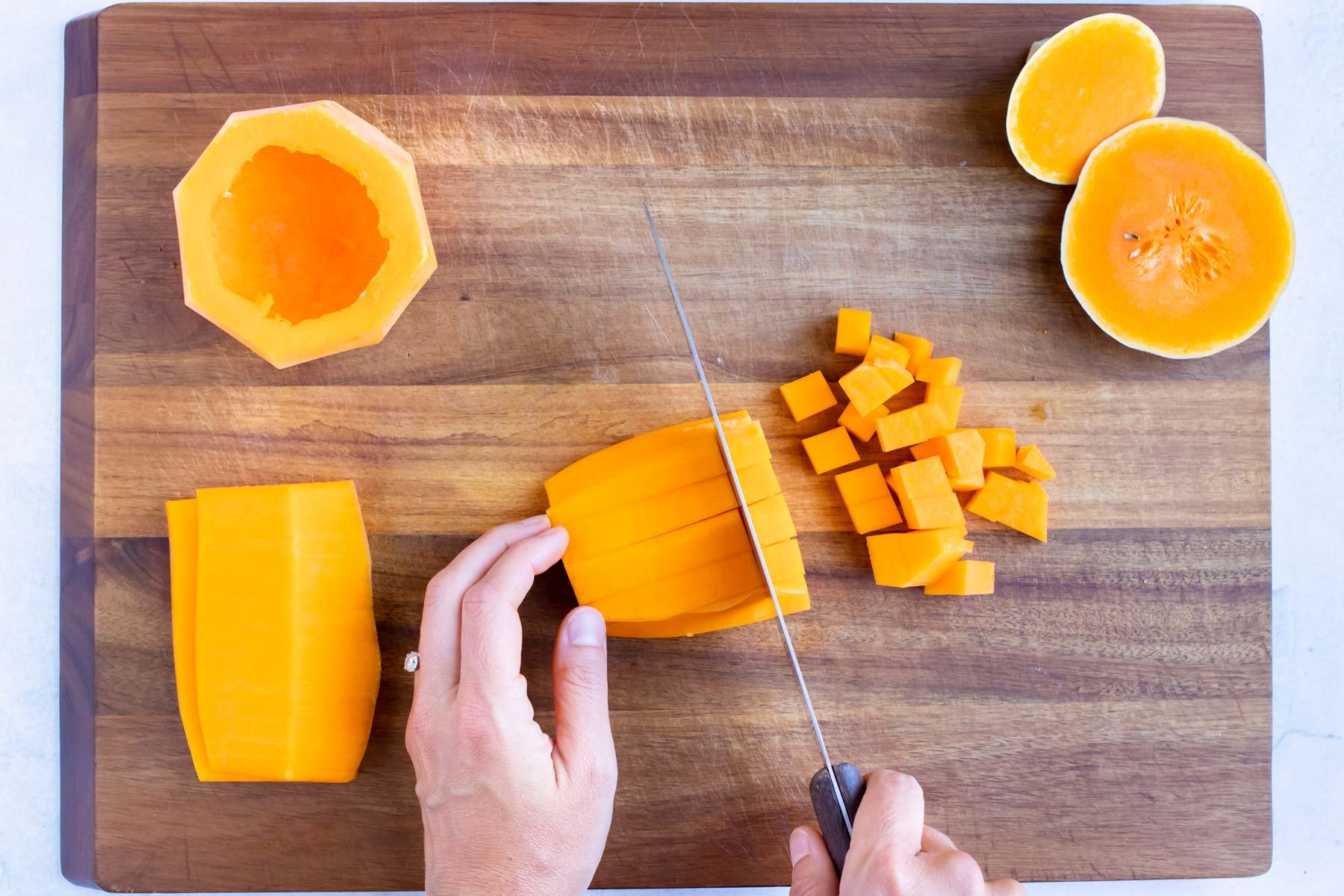 Prepared butternut squash is cubed before roasting in the oven.