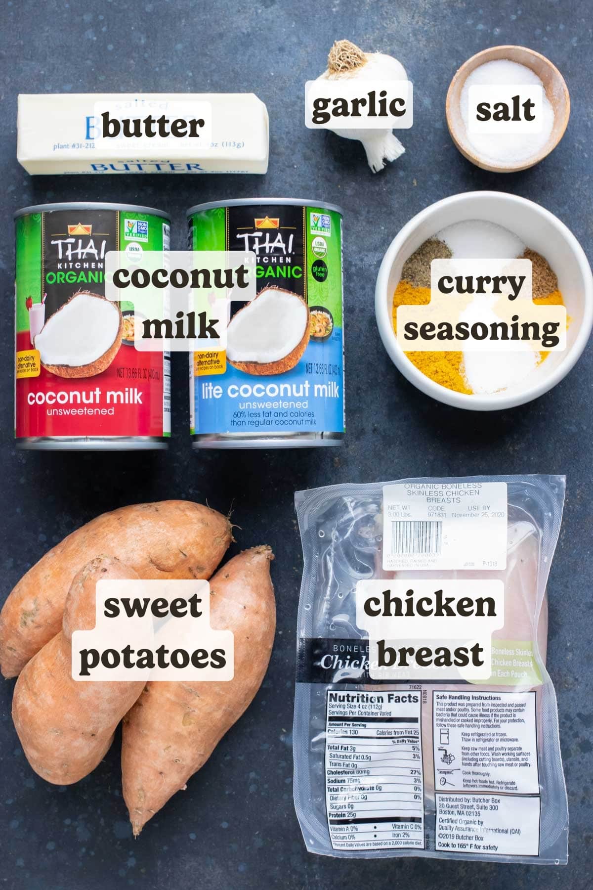Chicken, sweet potatoes, full-fat and lite canned coconut milk, butter, garlic, and curry seasoning for a slow cooker chicken curry recipe.