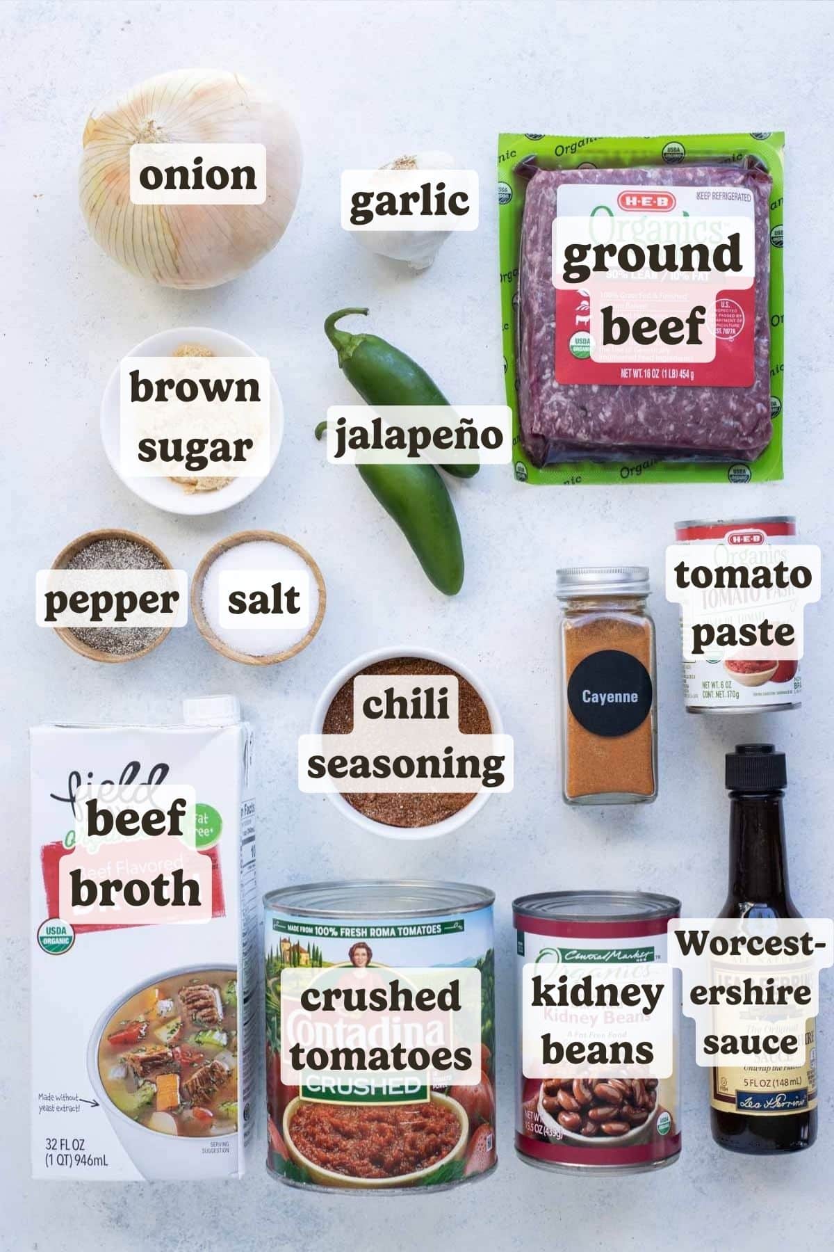 Ground beef, canned tomatoes, seasonings, peppers, broth, and sauces are the ingredients for this chili.