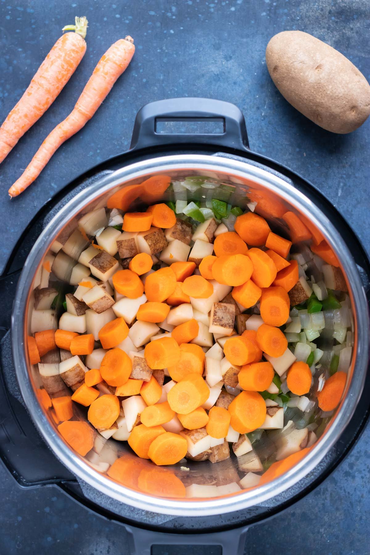 Carrots are added to the sauteed veggies.