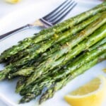 A quick, healthy, and easy side dish recipe for roasted asparagus with a lemon garlic sauce.