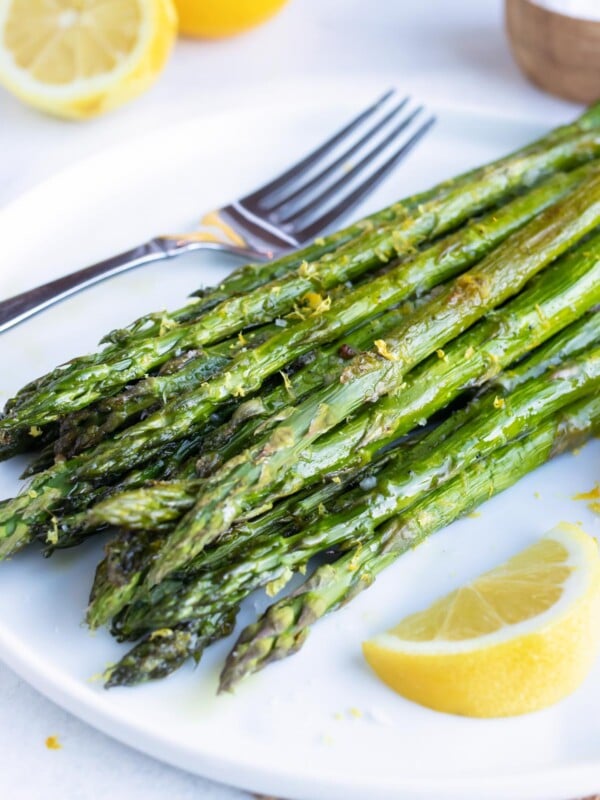 A quick, healthy, and easy side dish recipe for roasted asparagus with a lemon garlic sauce.