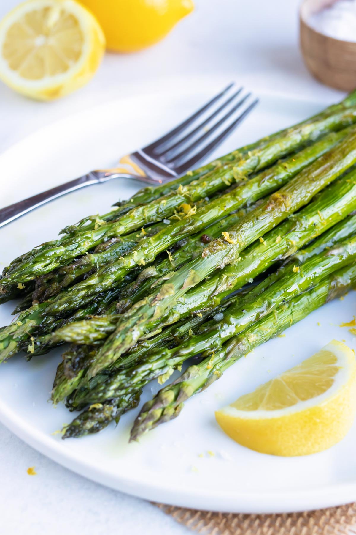 A quick, healthy, and easy side dish recipe for roasted asparagus with a lemon garlic sauce.