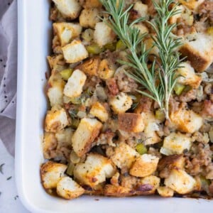 Gluten-free sausage stuffing is topped with fresh herbs before serving.