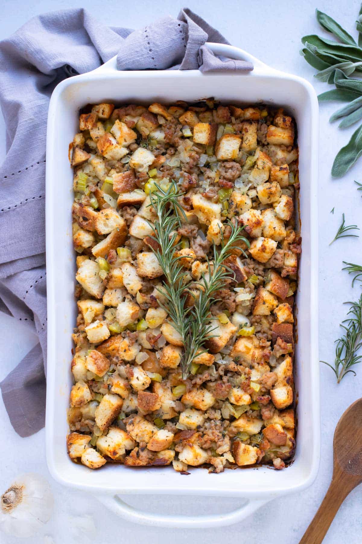 Sausage stuffing is served with fresh herbs and served at Thanksgiving.