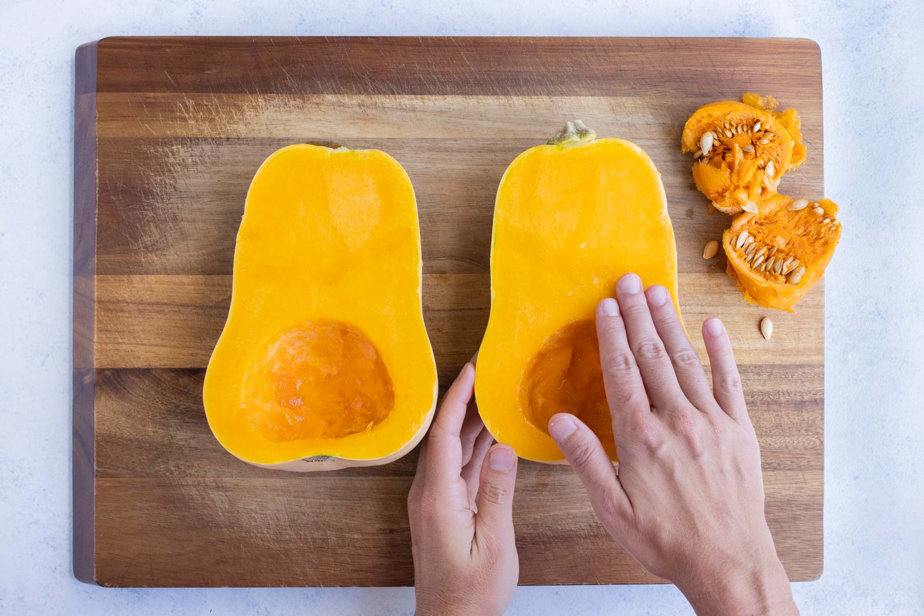 The butternut squash is covered in oil and salt.