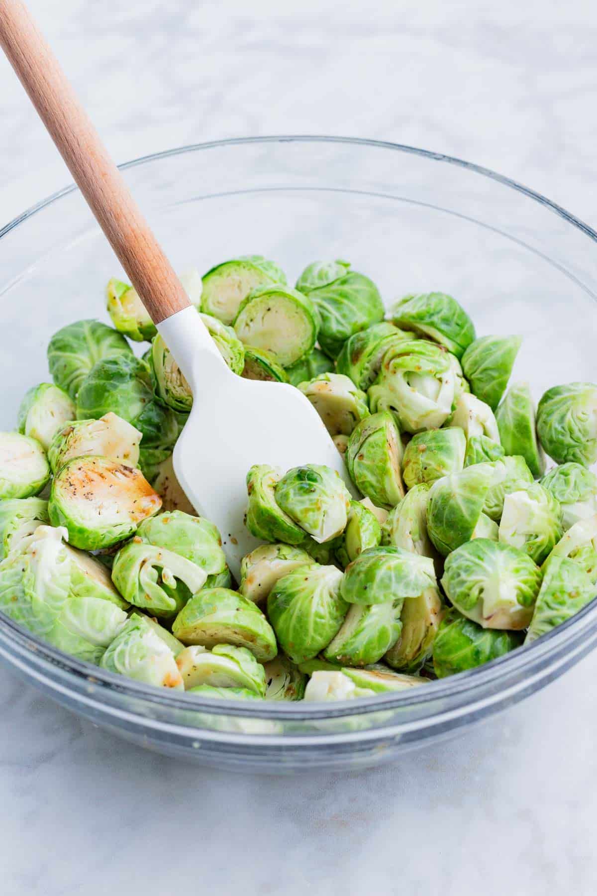 Brussels sprouts are coated with the sauce before roasting.