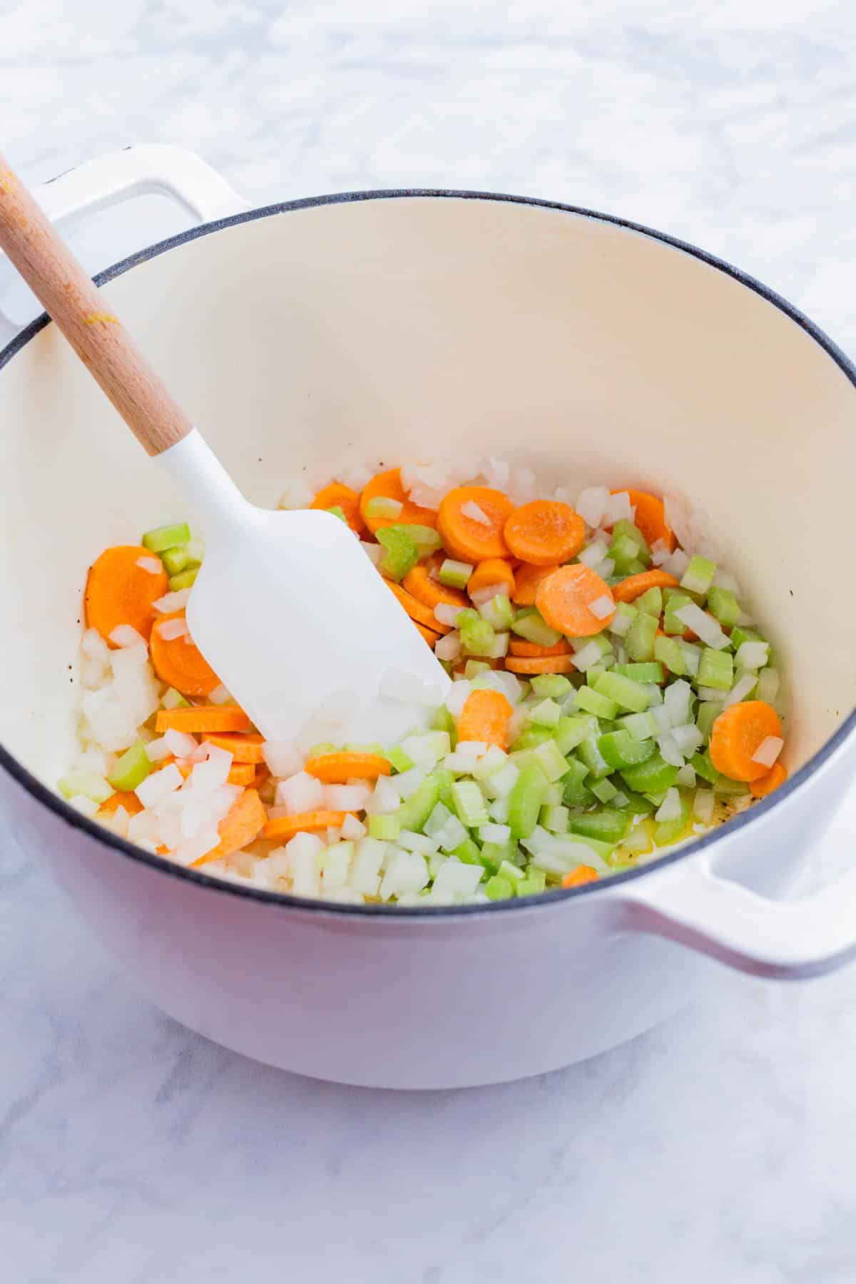 Carrots, onion, and celery are cooked in butter.