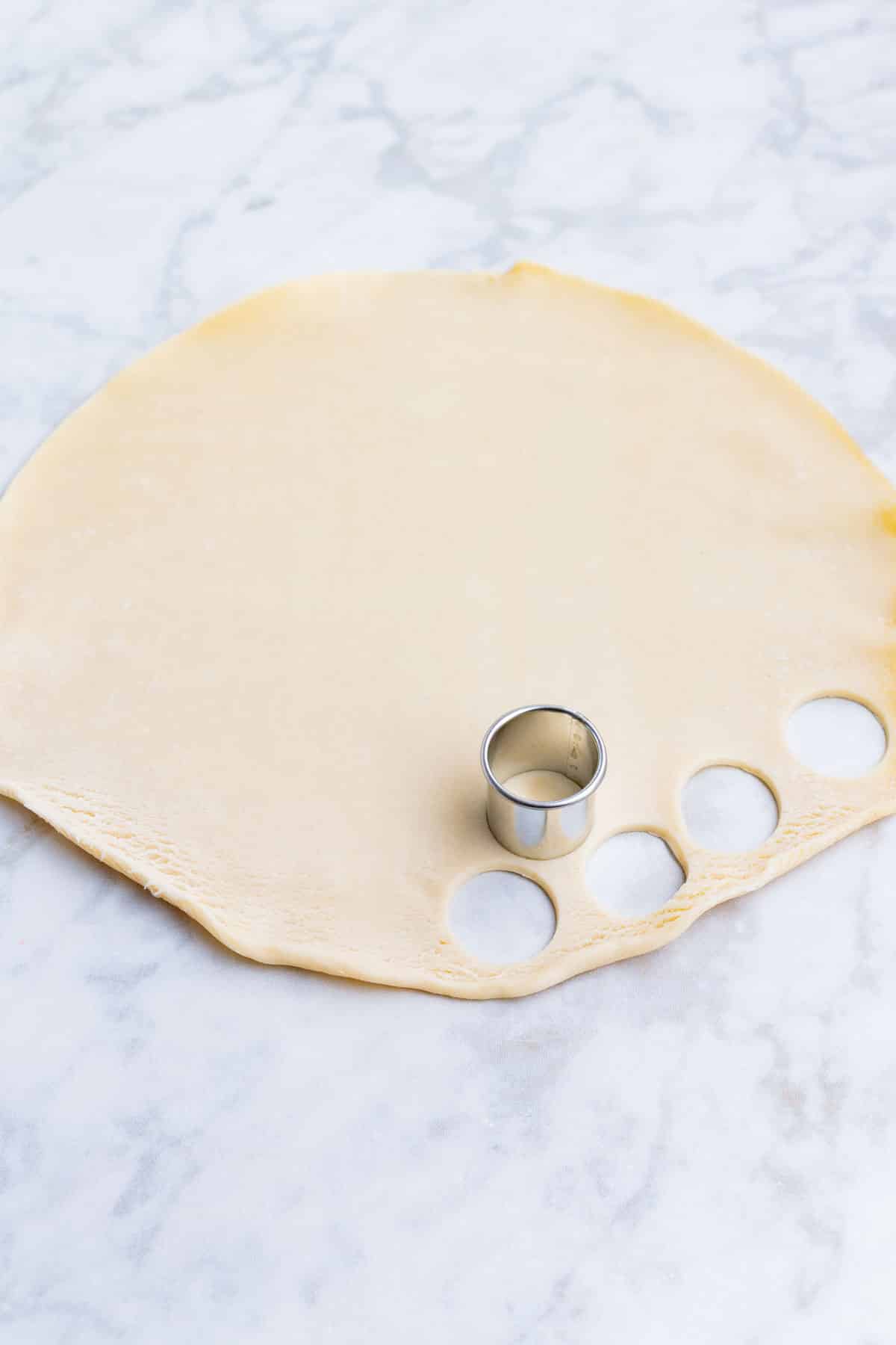 Pie crust is cut into small circles.