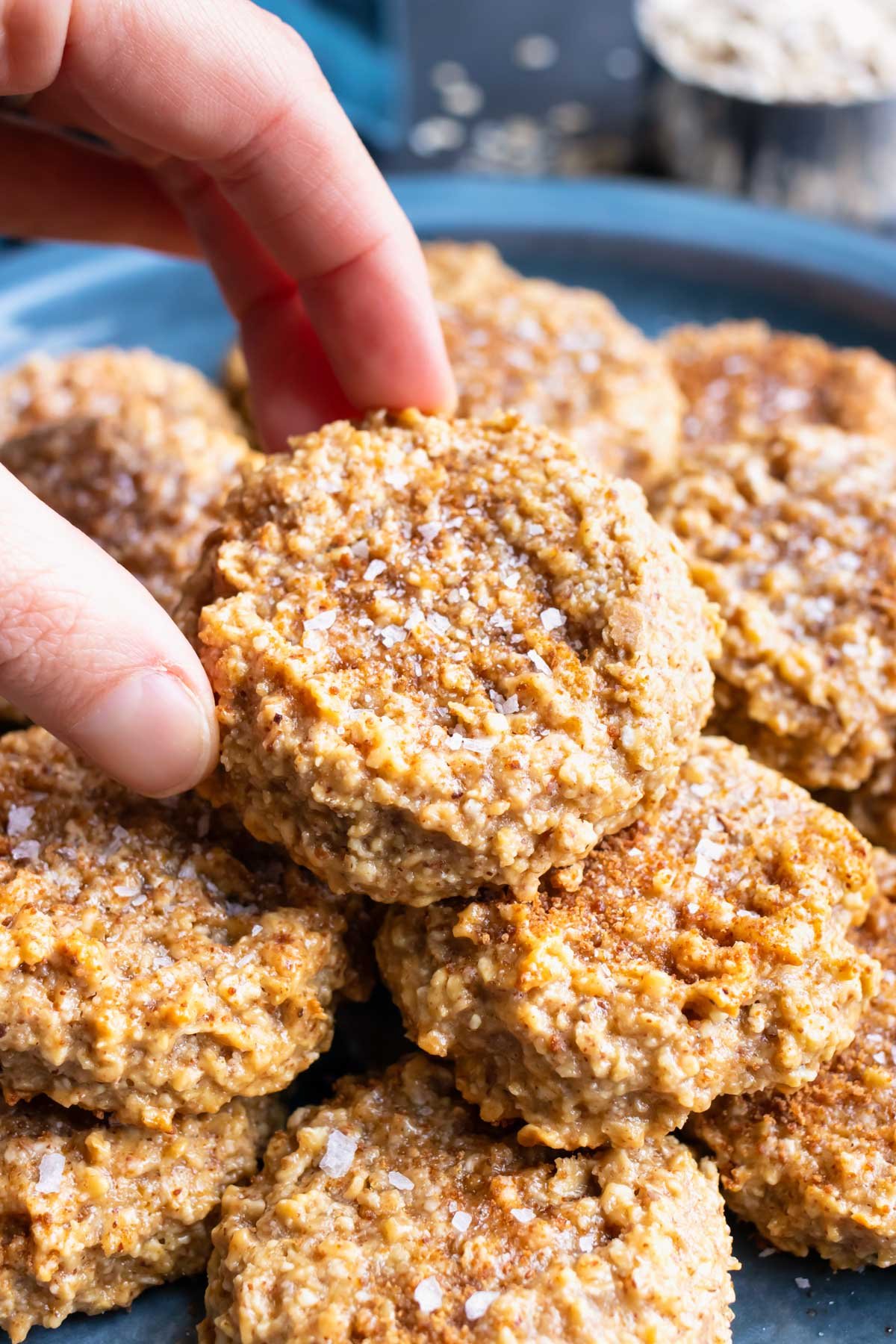 Gluten-free oatmeal cookies with almond butter on a serving plate.