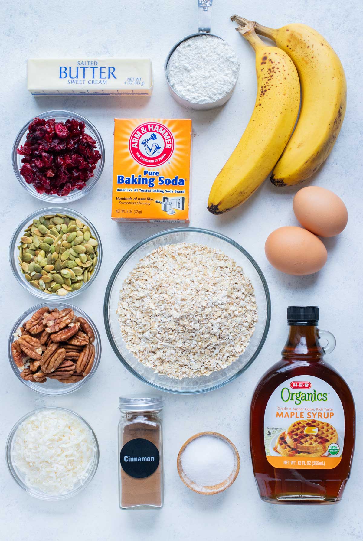 Eggs, flour, bananas, sweeteners, oats, baking soda, nuts, and dried fruit are all the ingredients in this recipe.