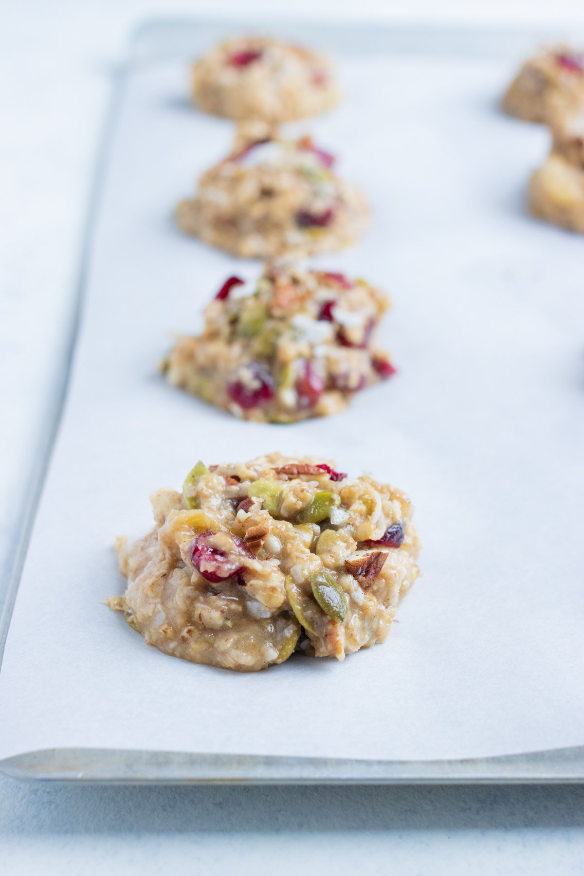 The cookies are set on a baking sheet before baking.