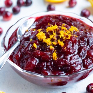 Cranberry orange sauce in a bowl is set on the counter.