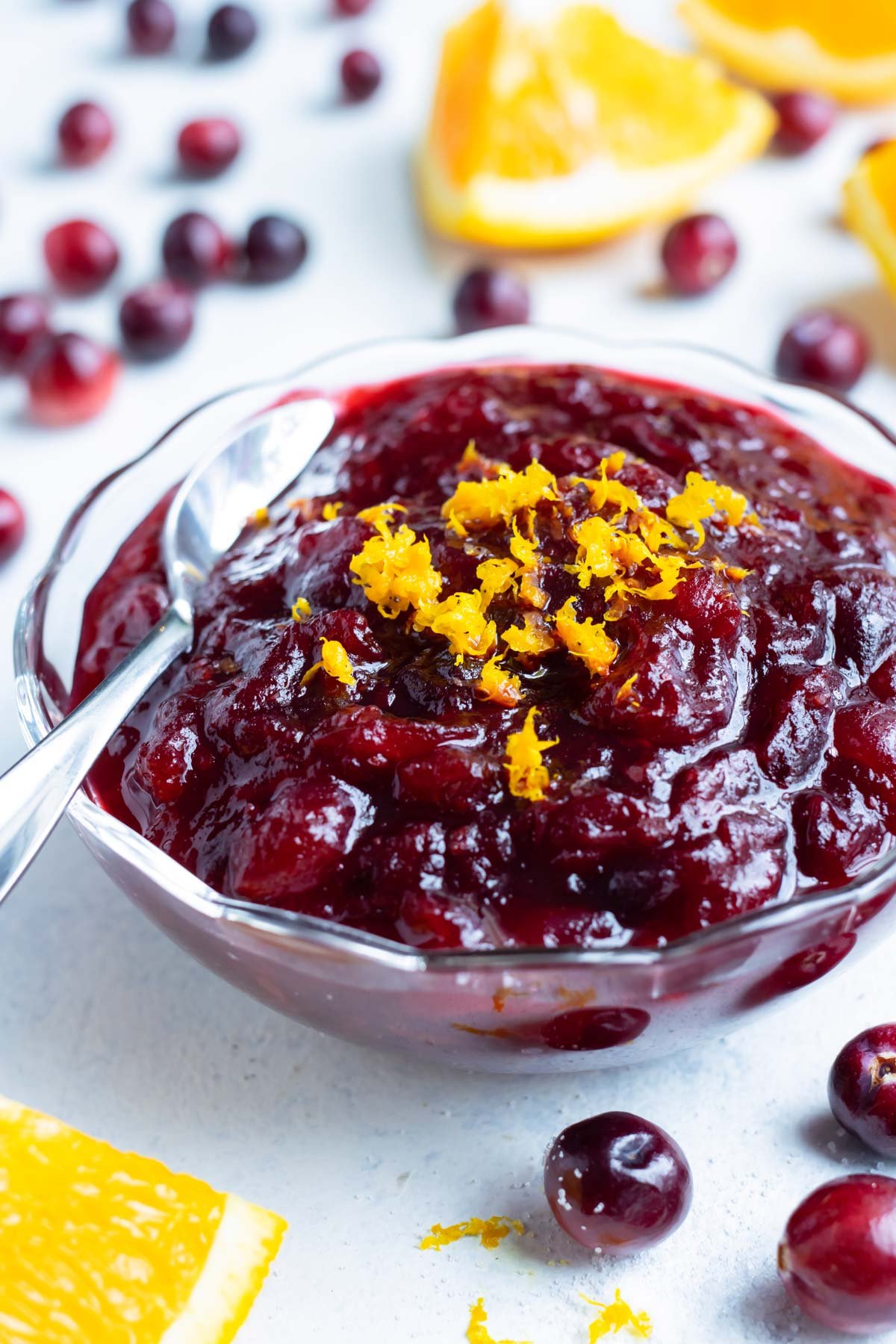 Cranberry orange sauce in a bowl is set on the counter.