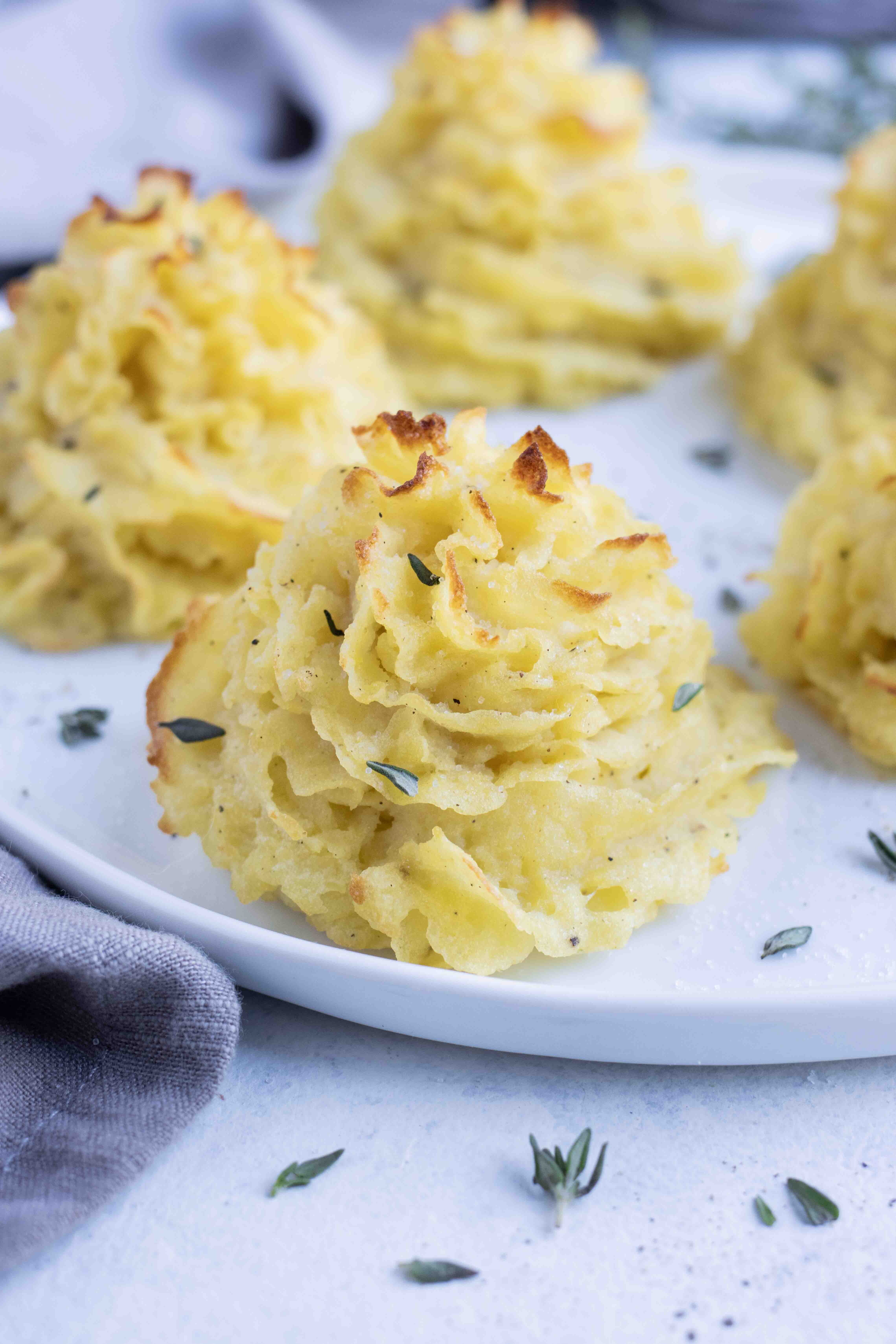 A plate of crispy duchess potatoes served for Christmas dinner