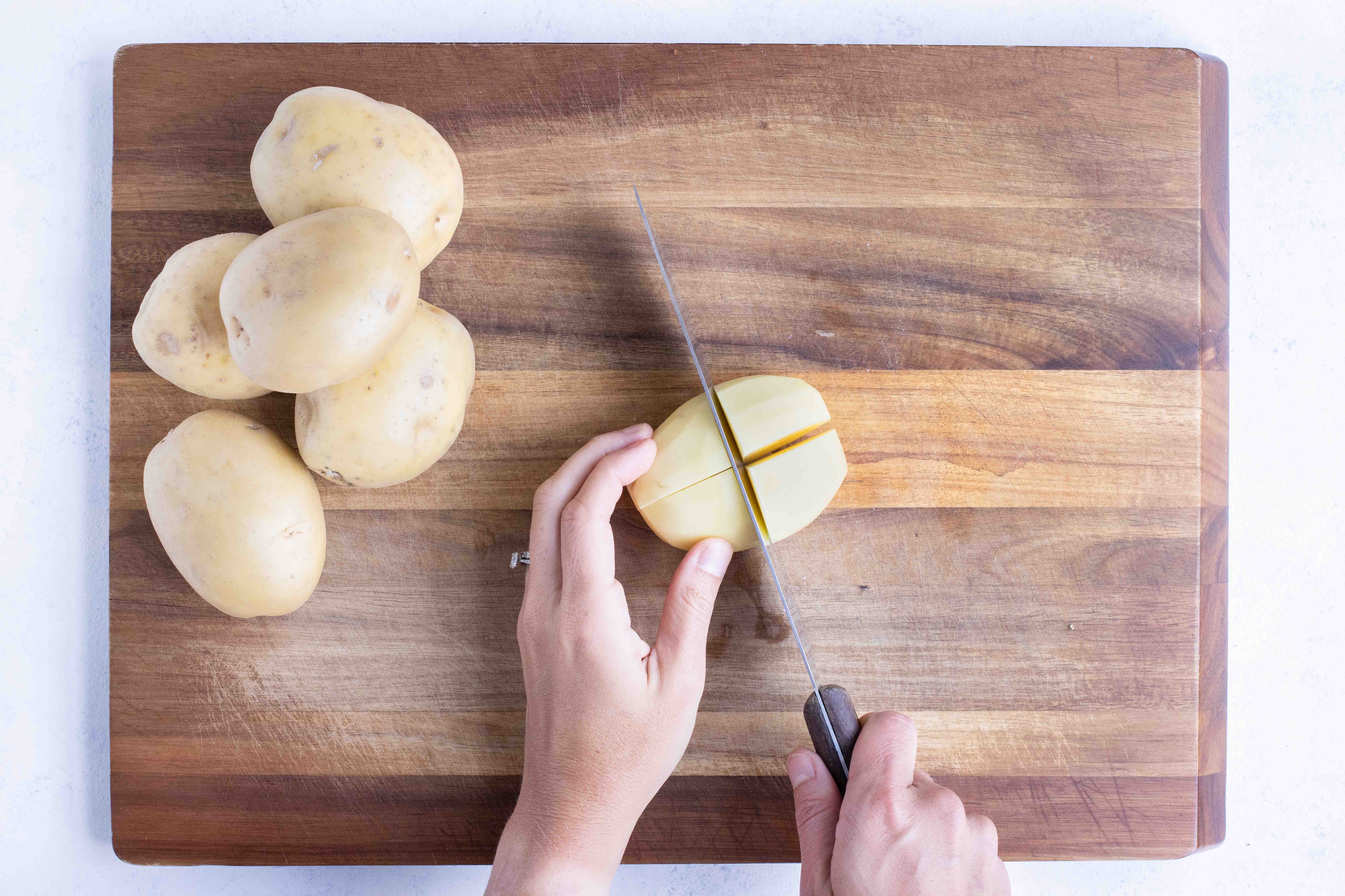 Peeling Yukon gold potatoes for homemade duchess potatoes