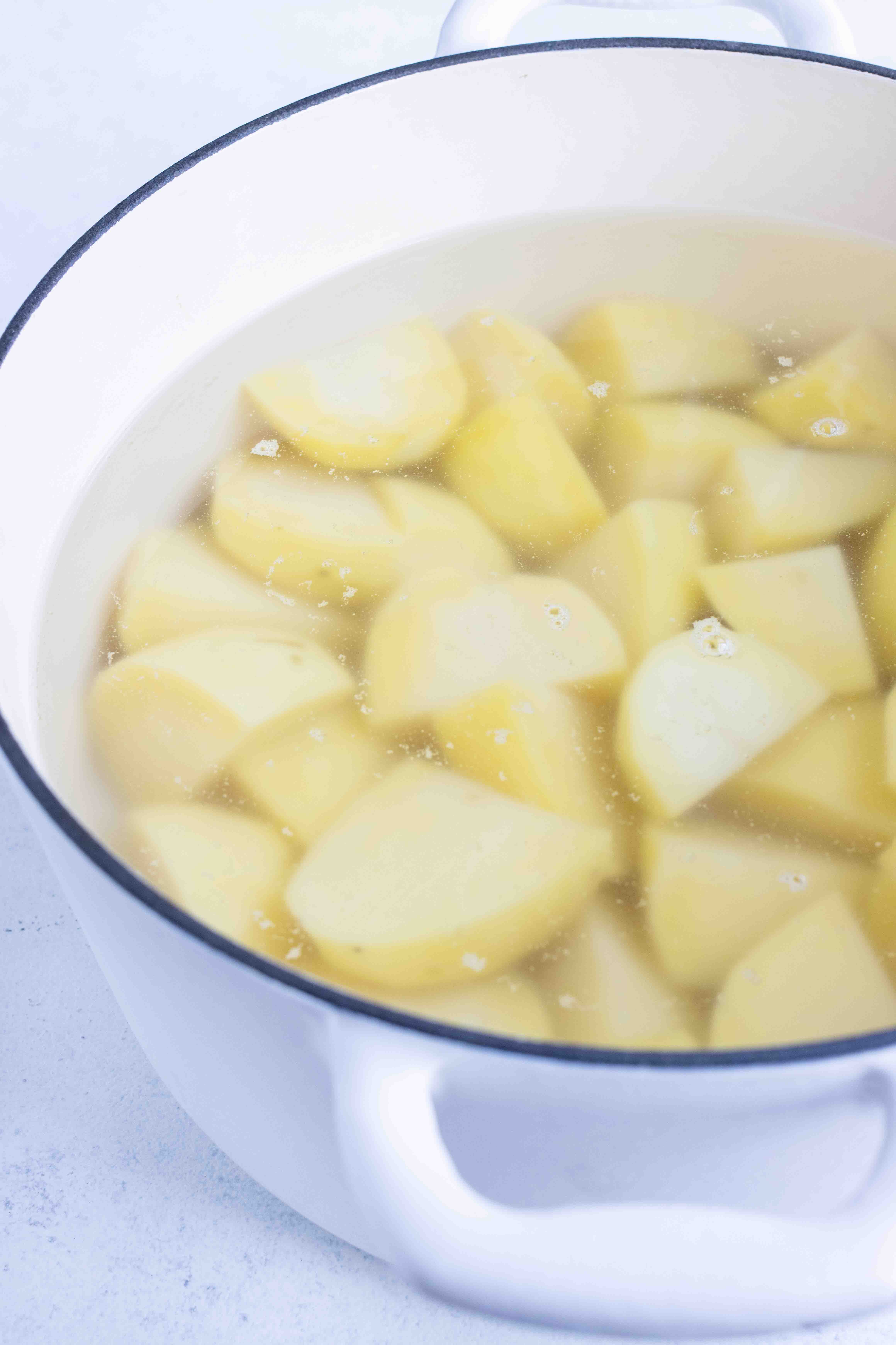 Boiled potatoes draining before they are riced for pommes duchesse