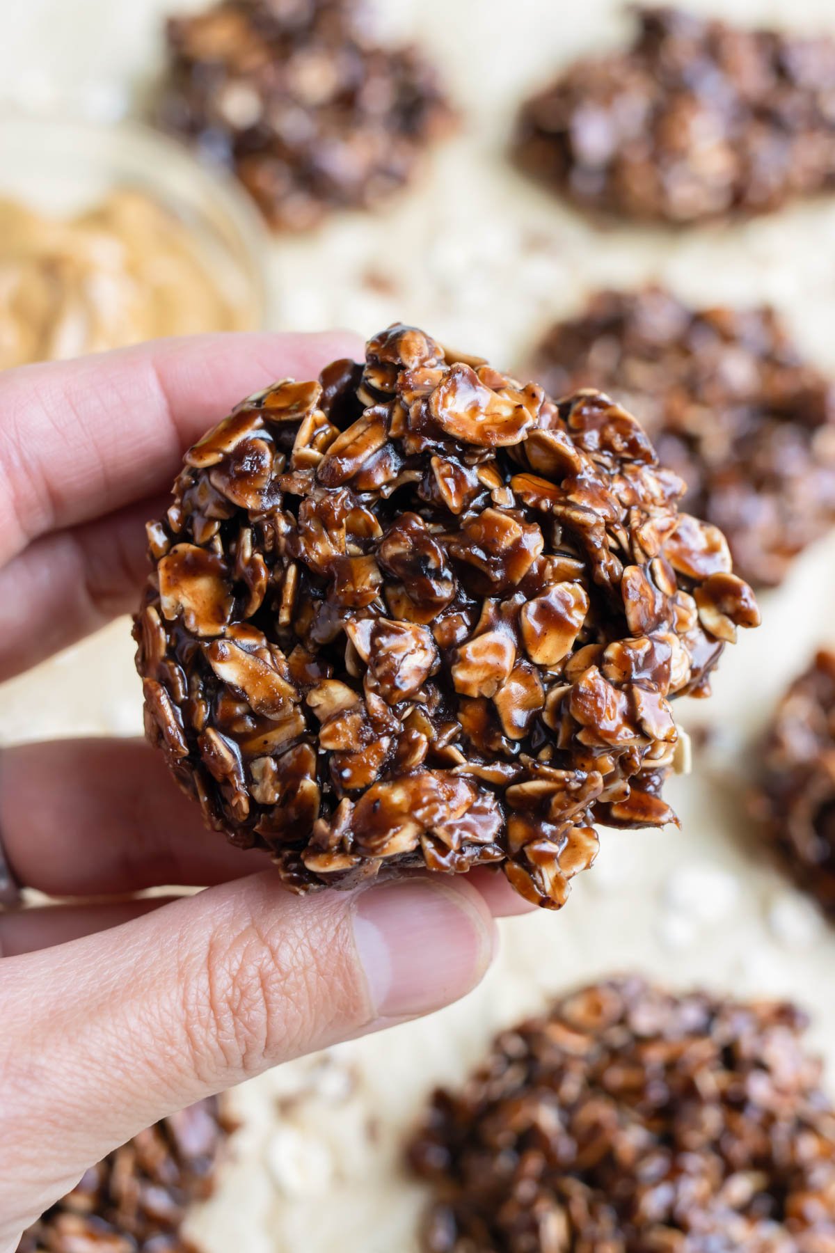 A hand is used to enjoy a gluten-free no-bake cookie.