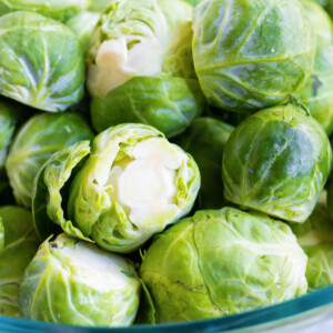 A bowl if full of Brussels sprouts.