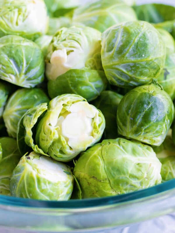 A bowl if full of Brussels sprouts.