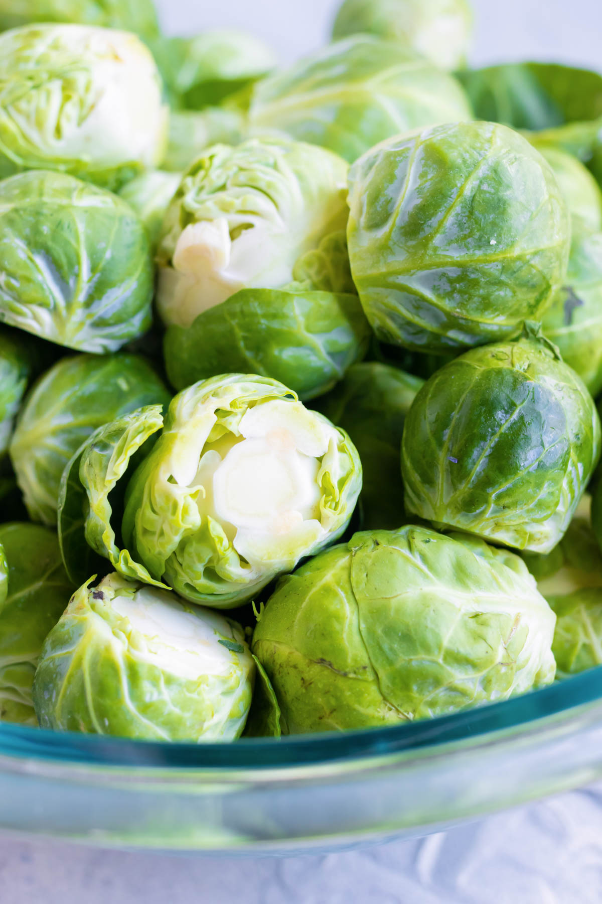 A bowl is full of Brussels sprouts.