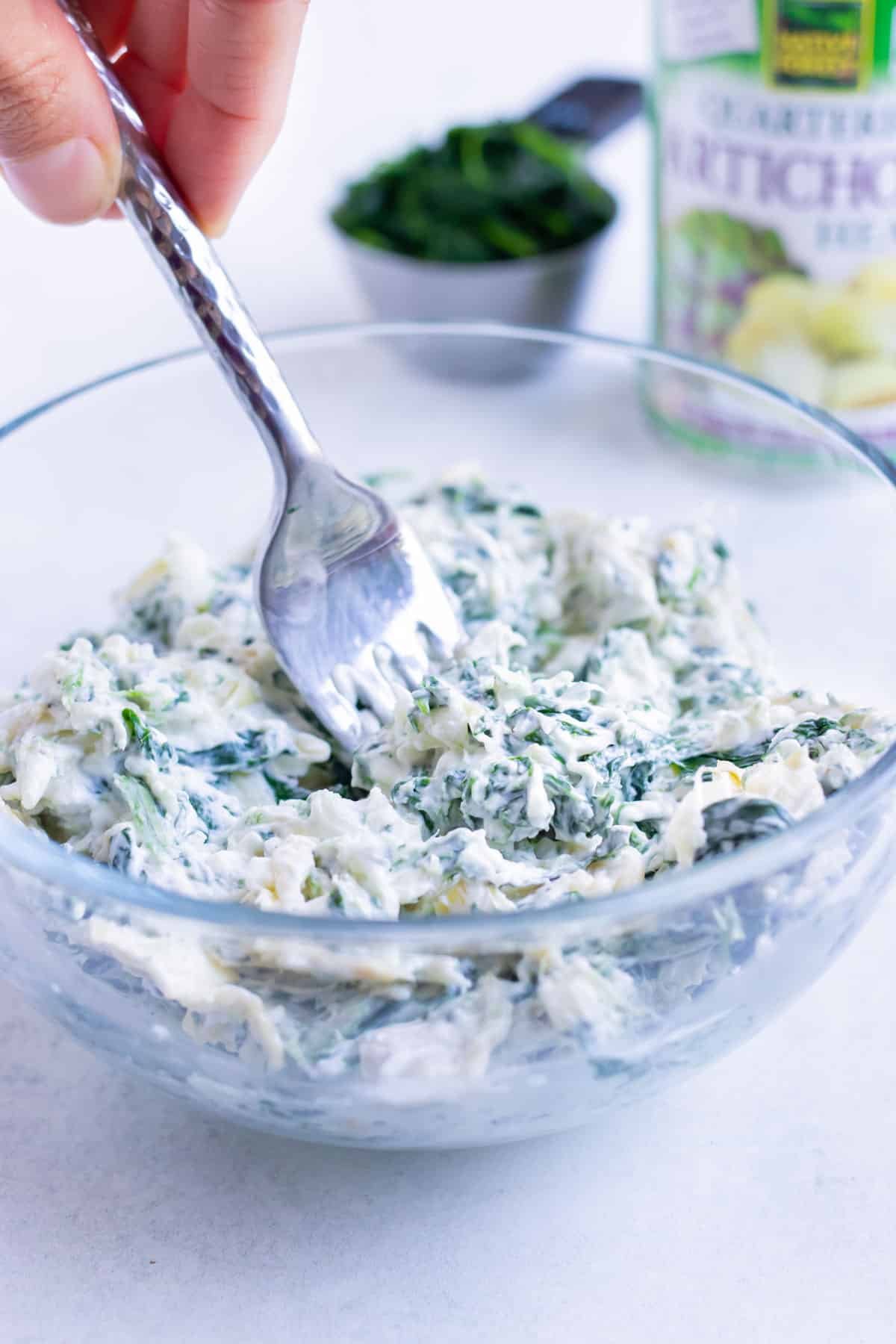 Low carb spinach artichoke filling is combined in a bowl for this easy main dish.