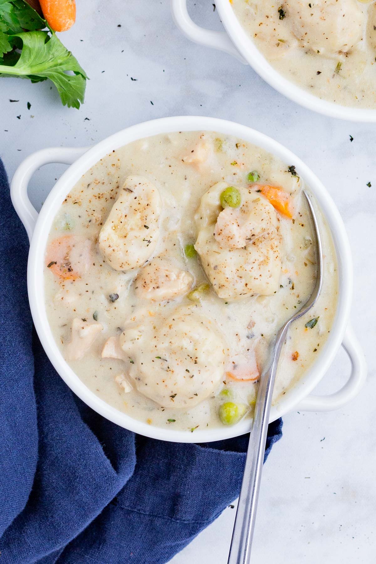 An overhead shot of creamy Chicken Dumpling soup in a bowl.