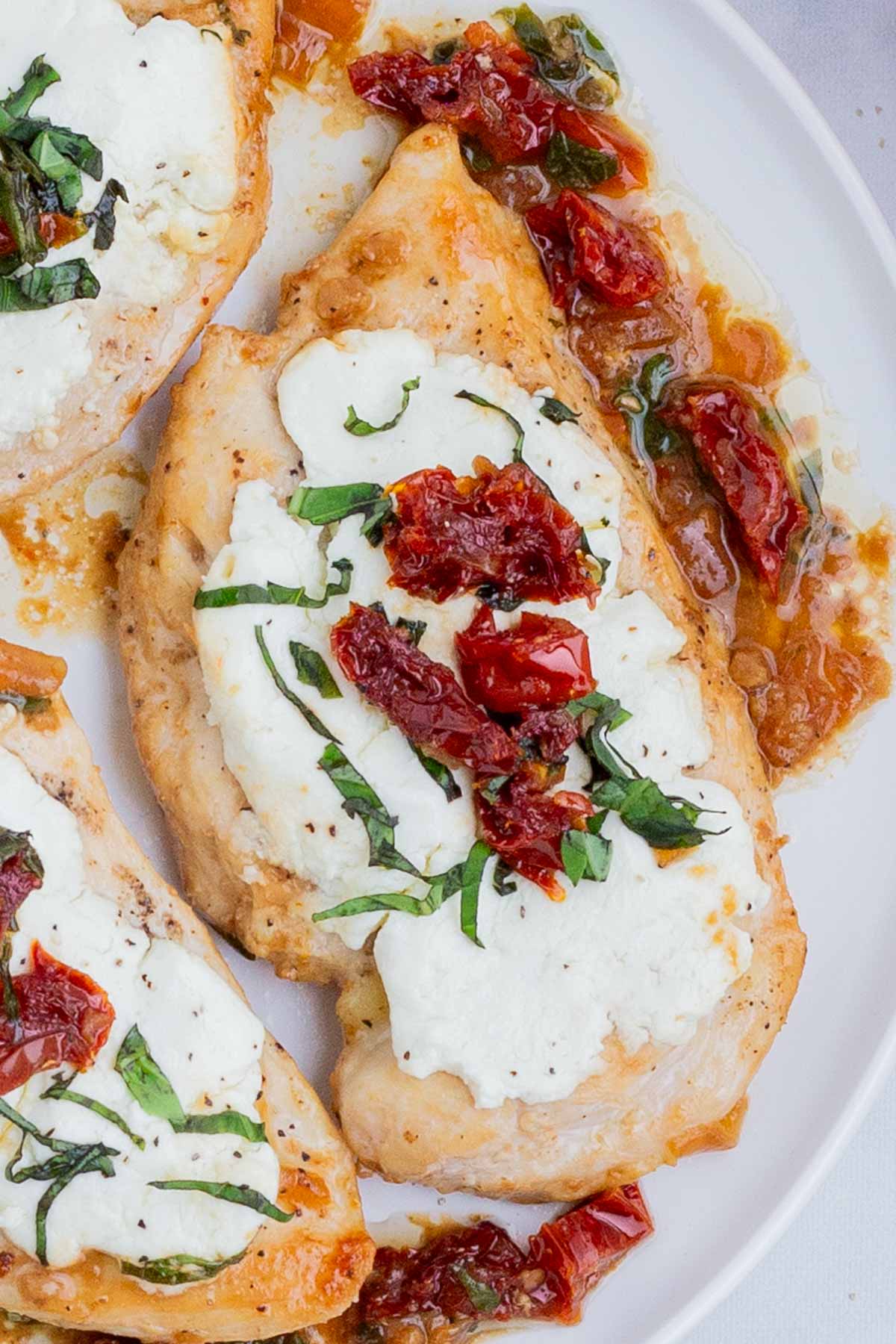Chicken breasts are cooked in a butter sauce and topped with goat cheese and sundried tomatoes.